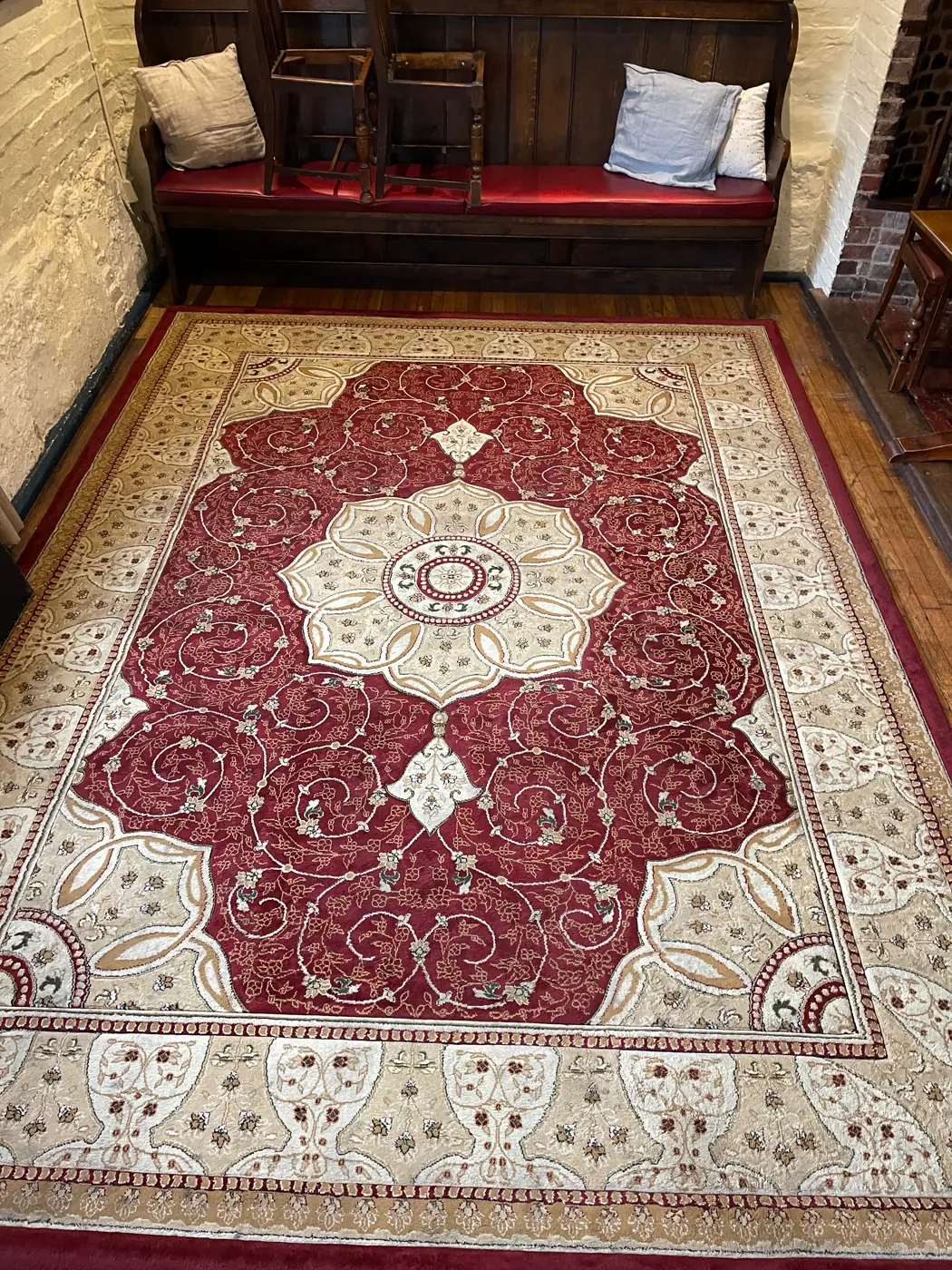The same detailed red and cream rug looking refreshed after cleaning