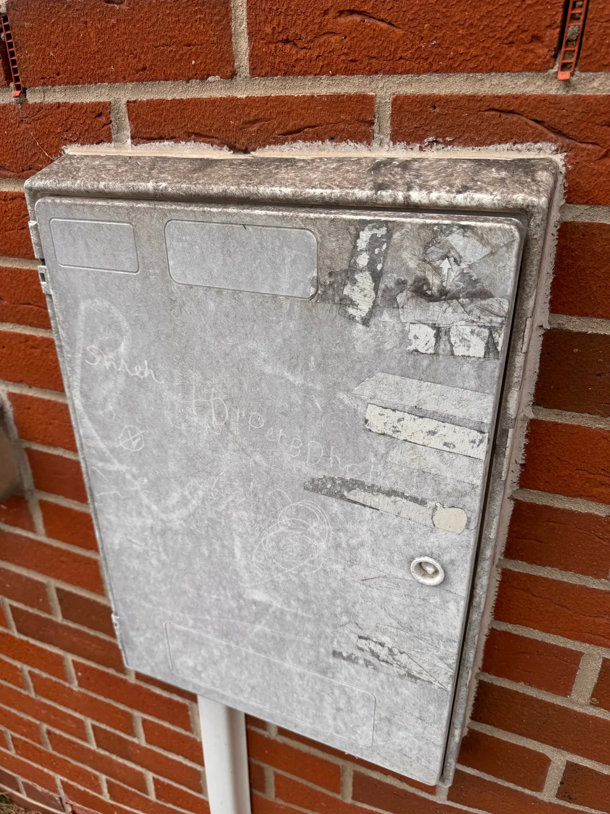 Solid-front exterior meter box before cleaning