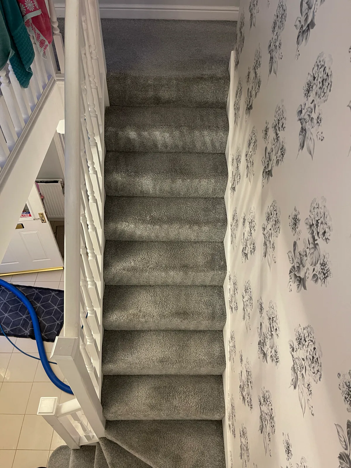 The same grey stair carpet after cleaning, with the dark marks reduced