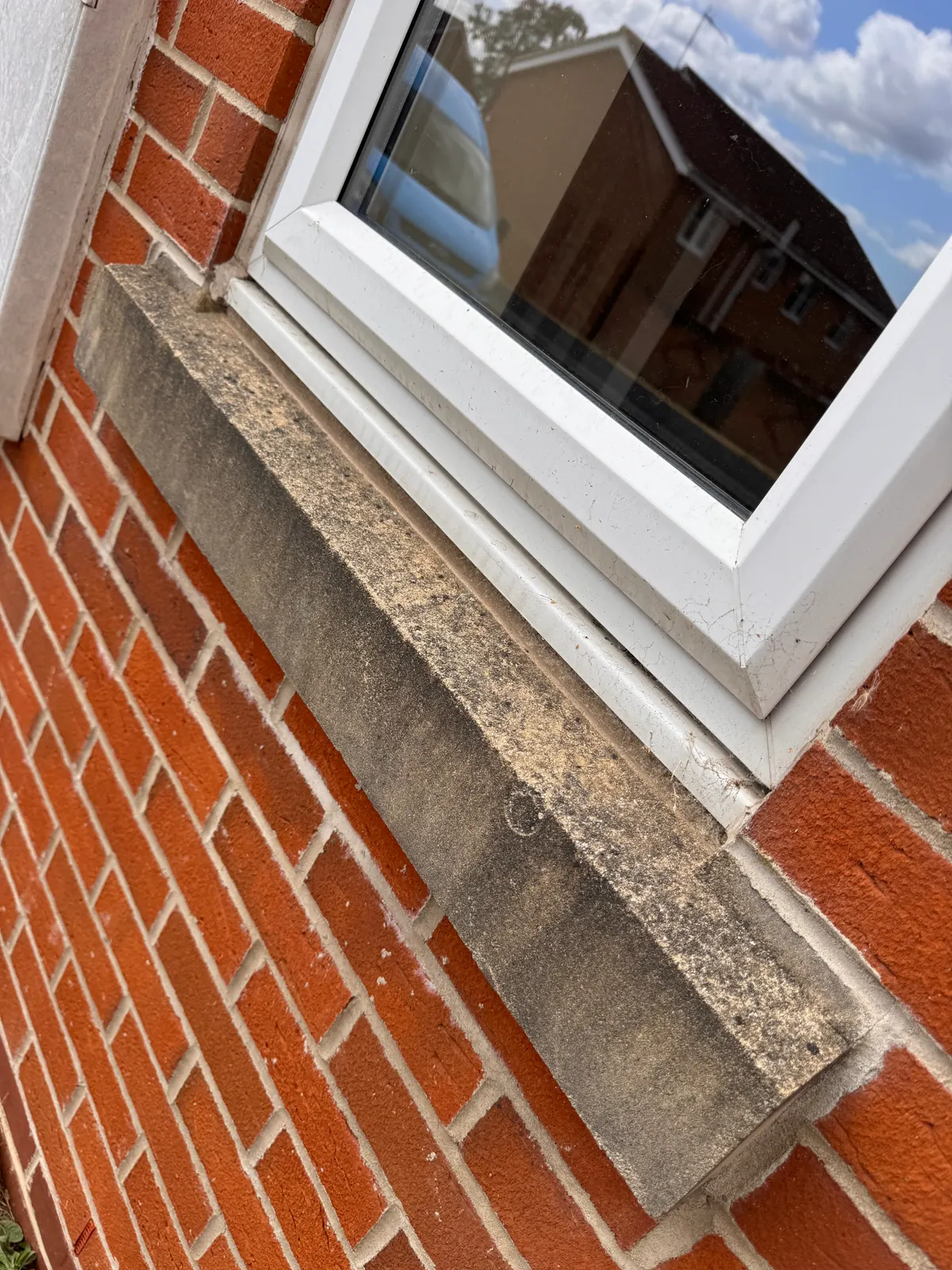 Stone exterior window sill before cleaning